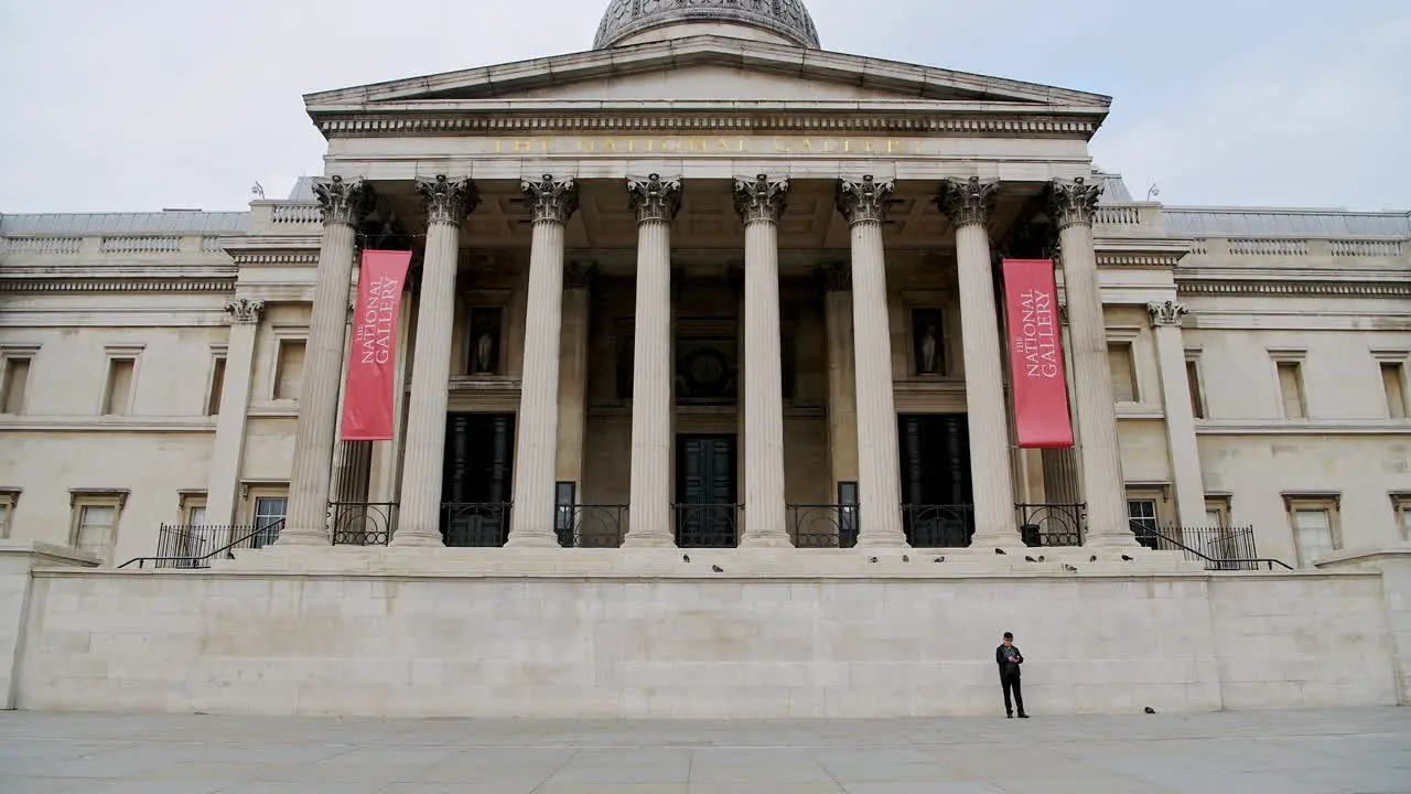 Quiet and empty Central London in Covid-19 Coronavirus lockdown with one person walking at The National Gallery at Trafalgar Square a popular tourist attraction in England UK