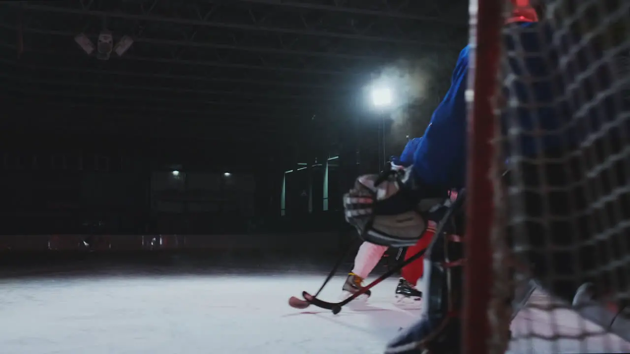 2 hockey players fighting for puck legs skates close view