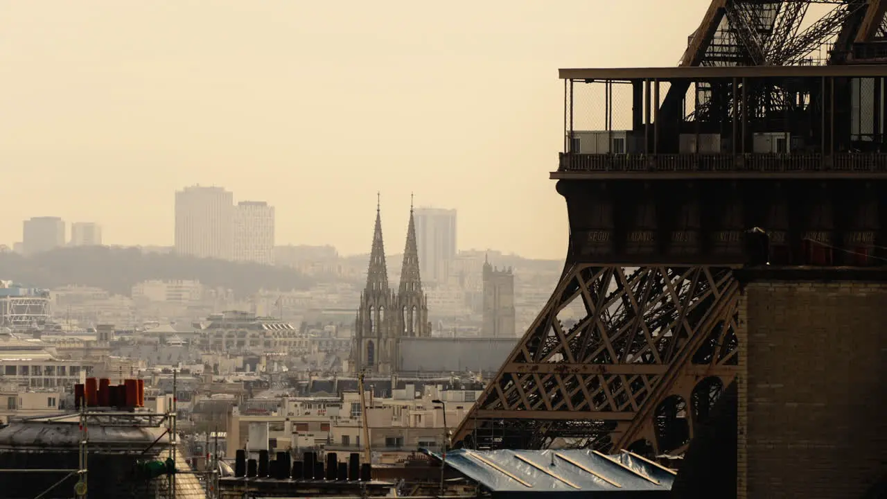 Hazy morning ins Paris France Cityscape with part of Eiffel Tower in foreground and city buildings and church in distance