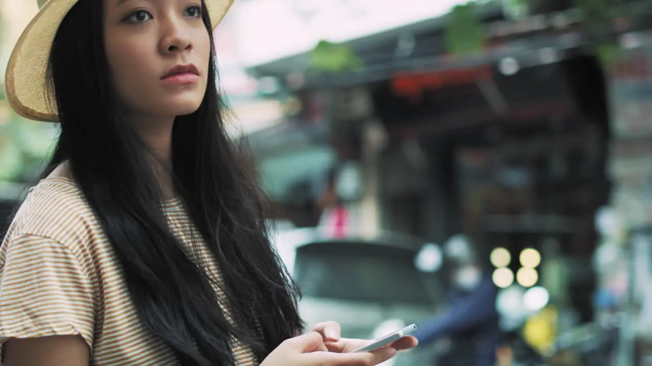 Handheld view of Vietnamese woman using smart phone