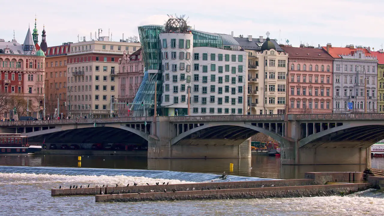 Dancing House and Jirásek bridge over Vltava river in Prague city