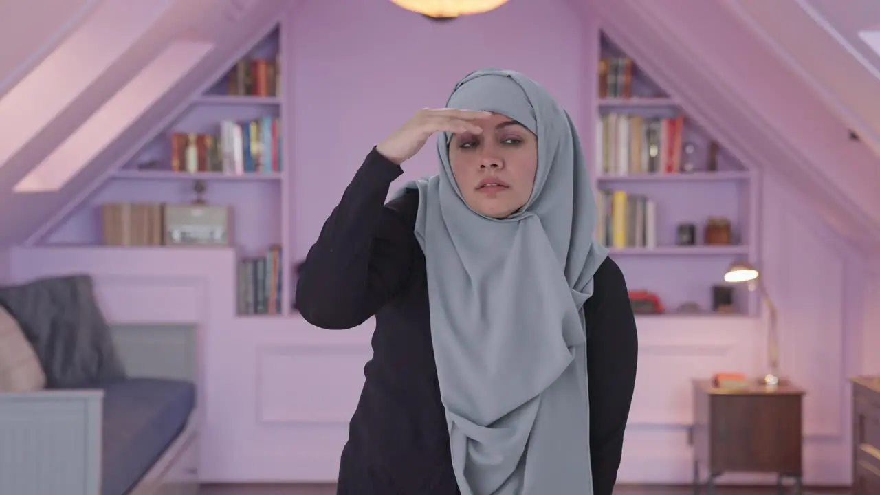 Confused Muslim woman searching for someone