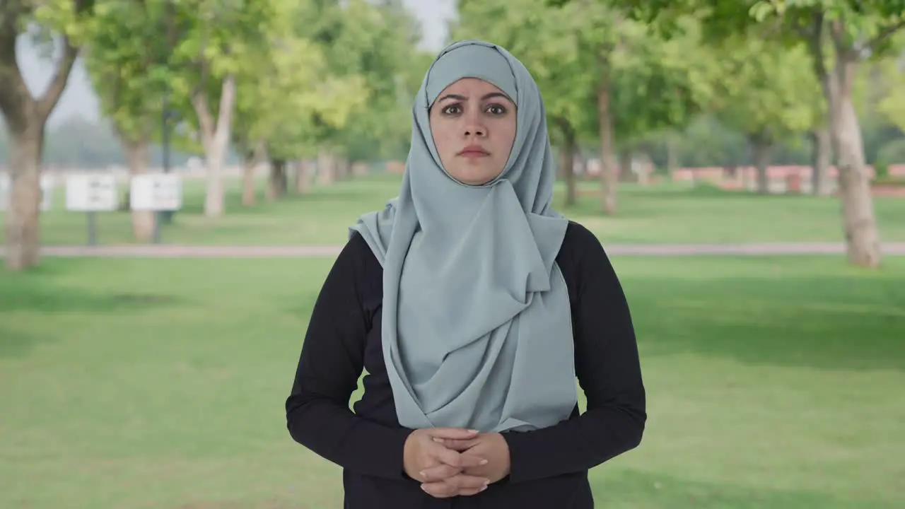 Angry Muslim woman looking at the camera in park