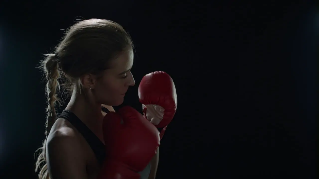 Woman boxer kicking air in slow motion