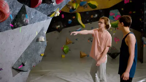 Two friends in a climbing gym