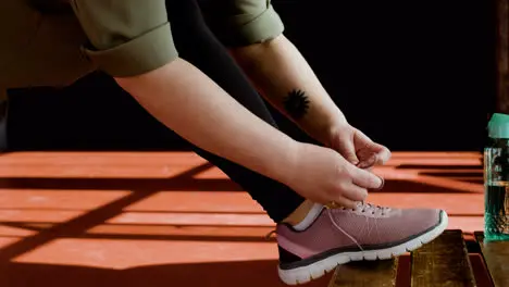 Woman tying shoelaces