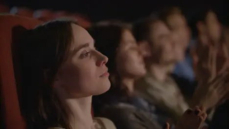 Beautiful girl looking theatre performance Woman applauding in theatre