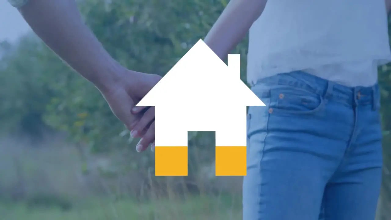 Coupel holding hands and house filling yellow