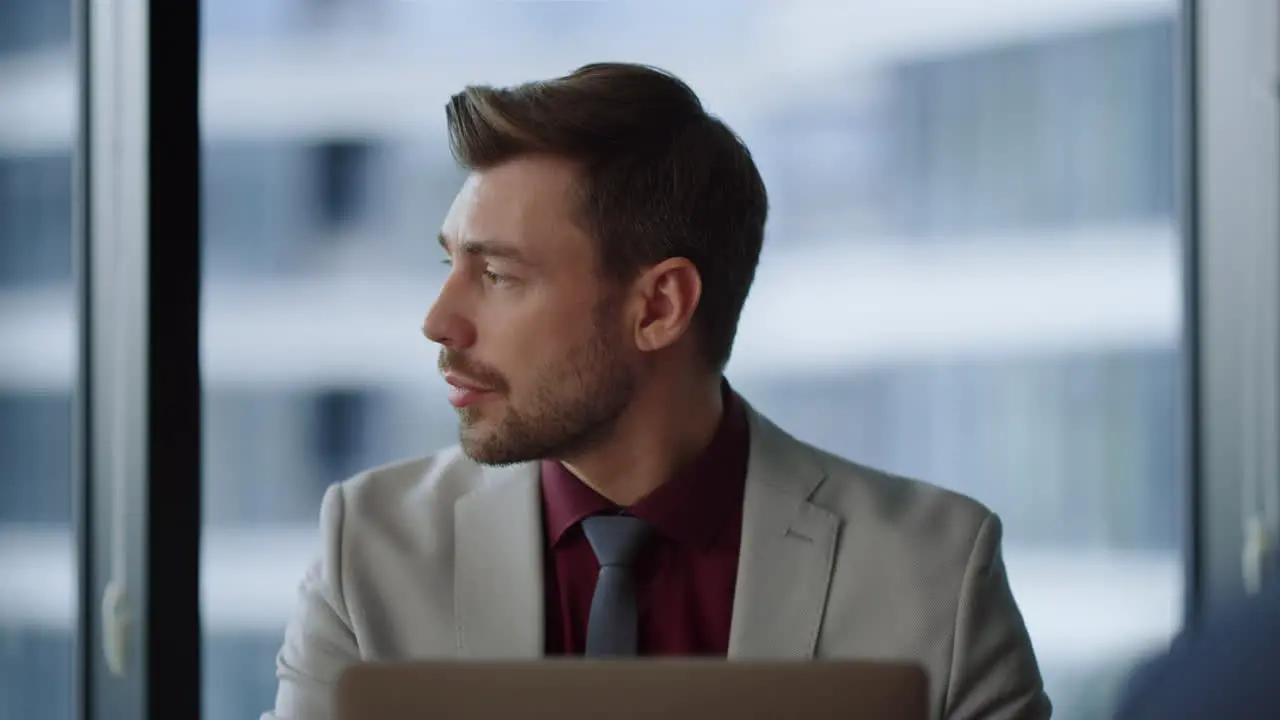 Focused man ceo working using computer looking laptop screen in corporate office