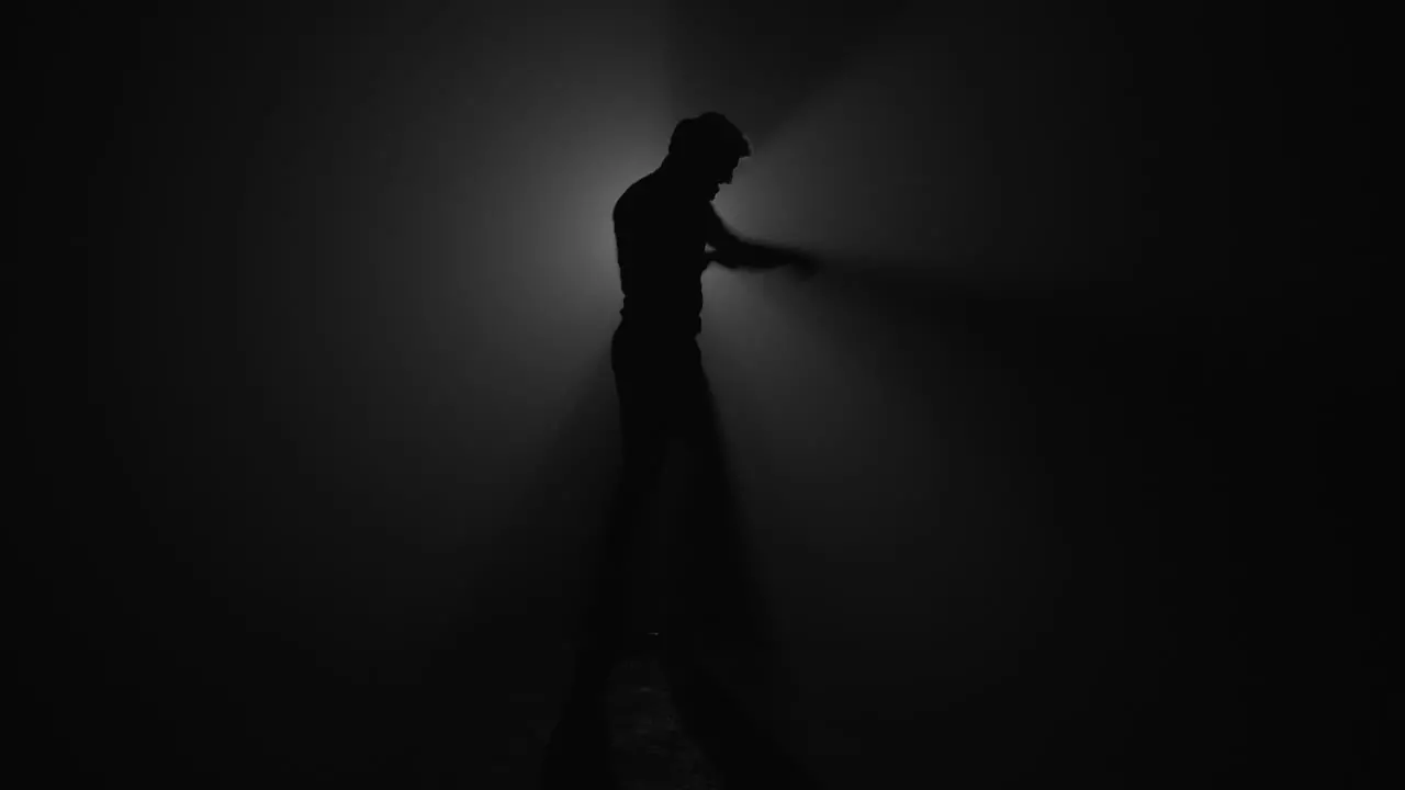 Silhouette of fighter punching in dark