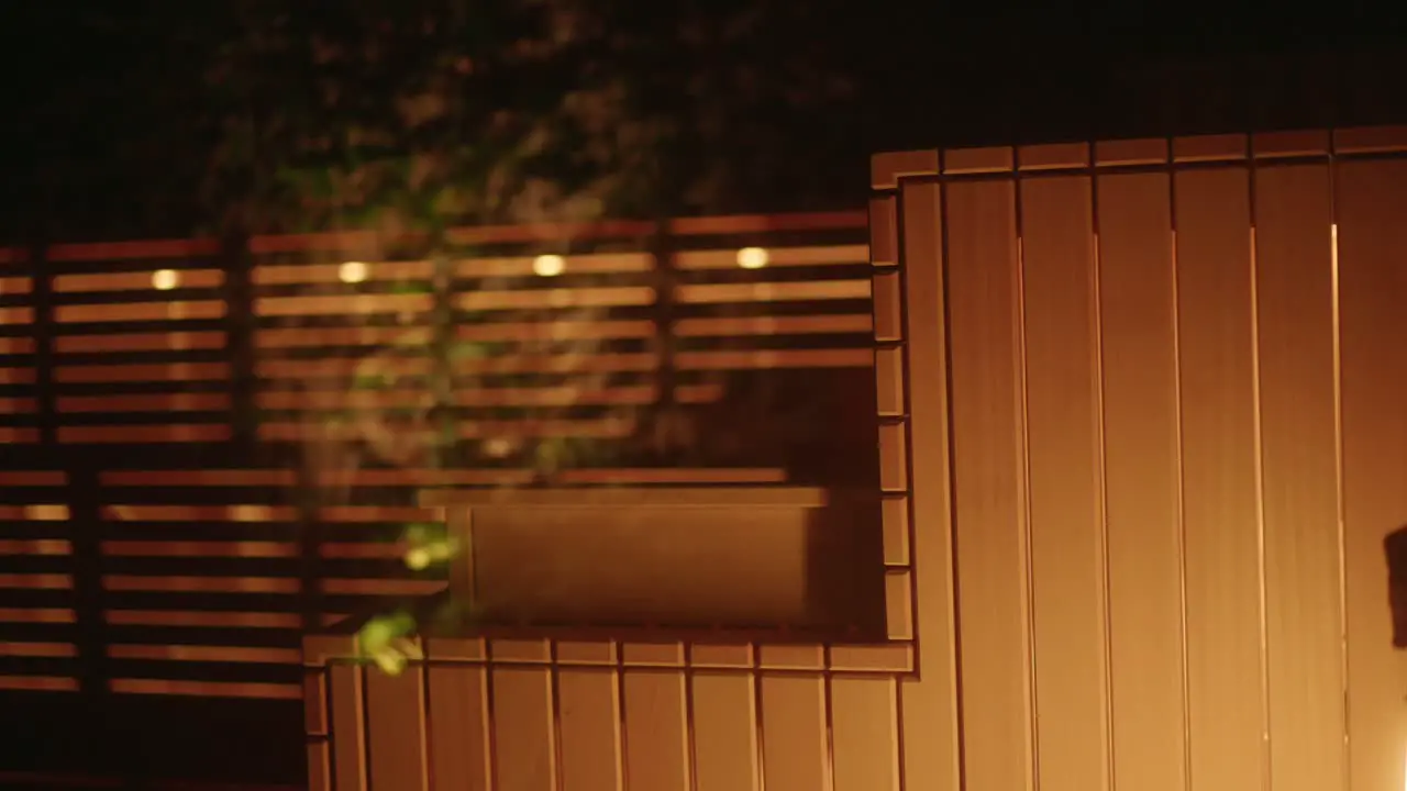 Woman entering cozy sauna during winter in wellness hotel