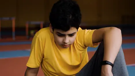 Boy resting in running track