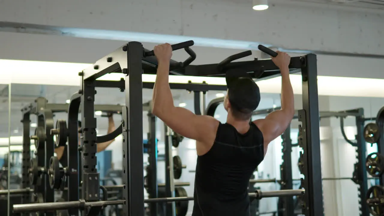 Fit Adult Man Doing Pullups in Gym