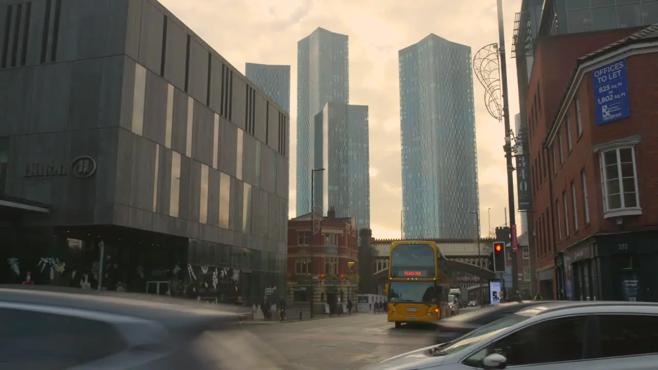 View of Manchester city center with busy traffic and skyscrapers in the background