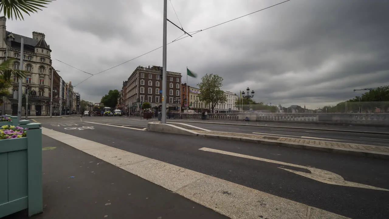 Time Lapse of traffic and people walking by during the day in Dublin City Center in Ireland