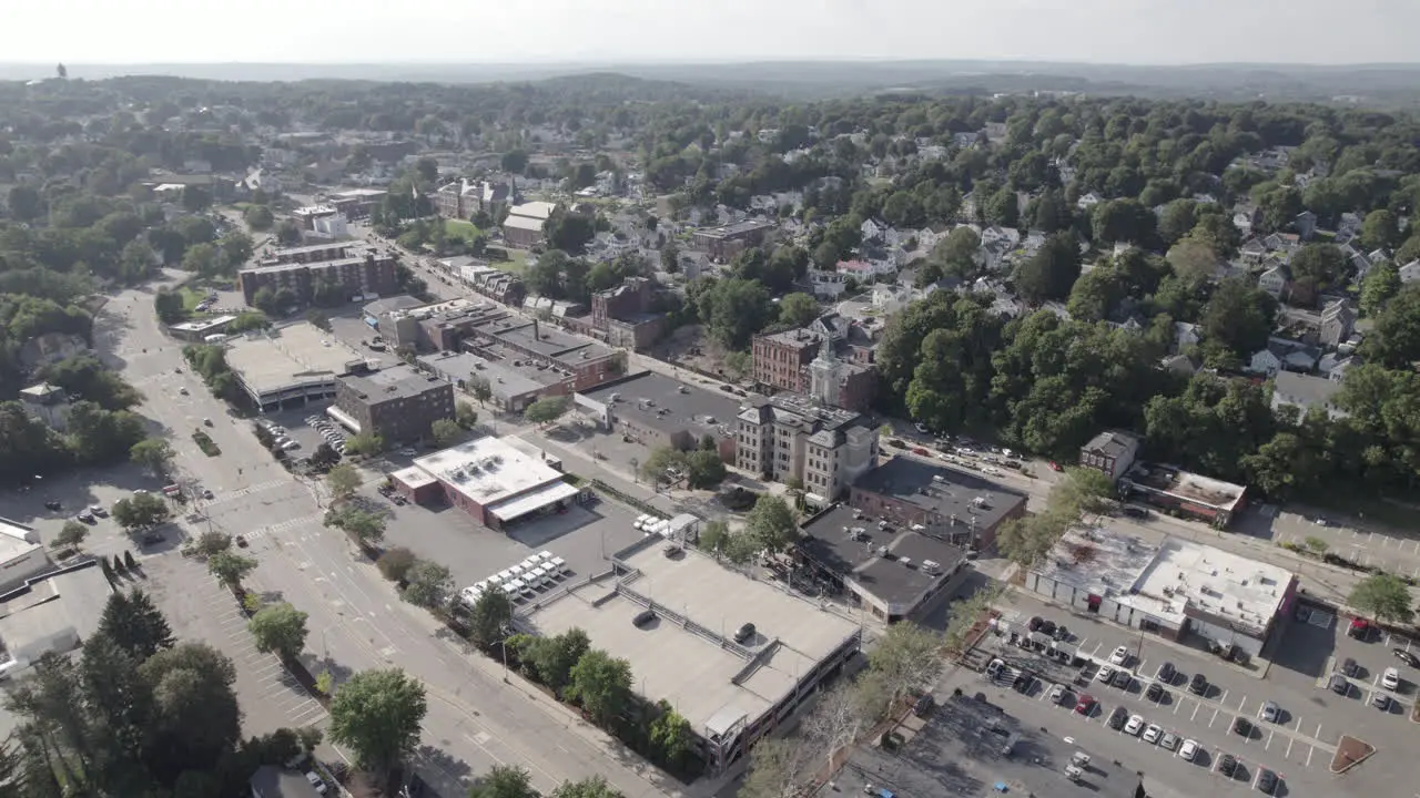 Flying slowly up high wide panorama of Marlborough Massachusetts down town and surrounding neighborhoods and streets