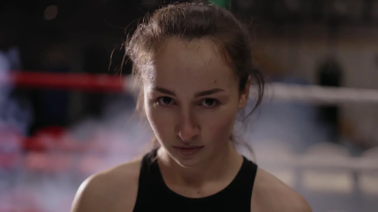 Portrait Shot Of Pretty Female Fighter With Wrapped Hands Looking At Camera