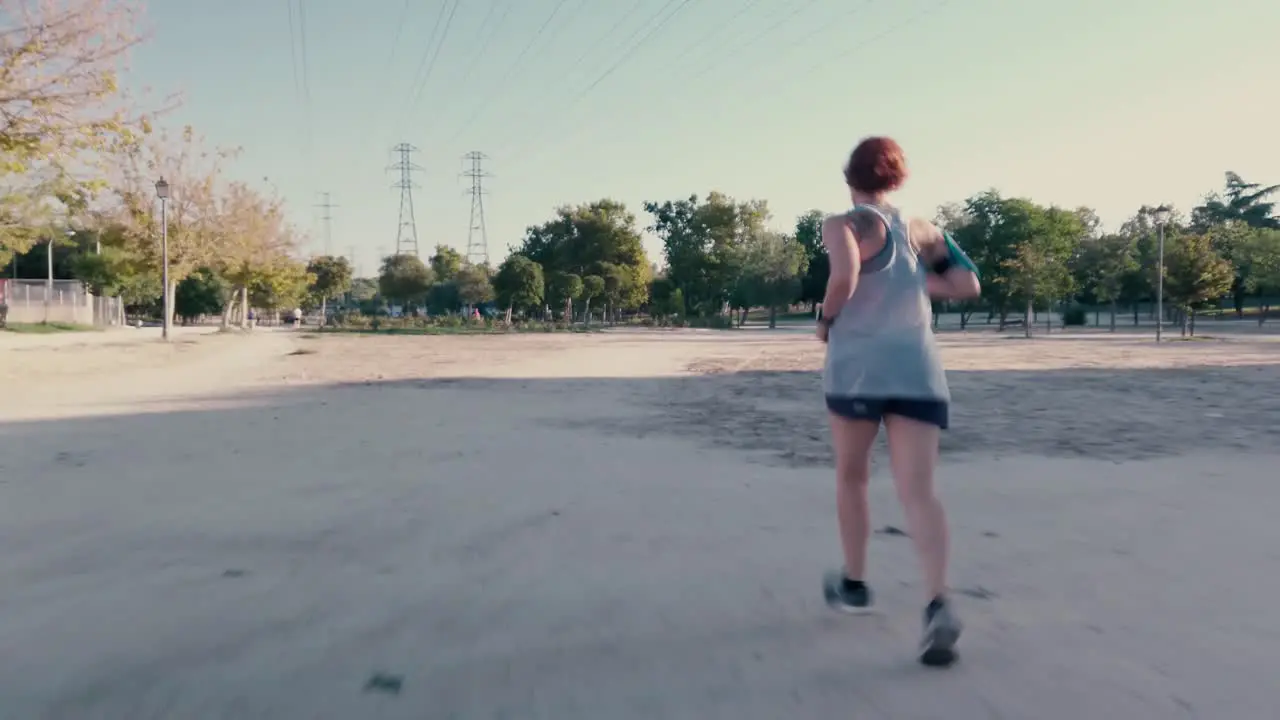 A shot following a female runner in a park