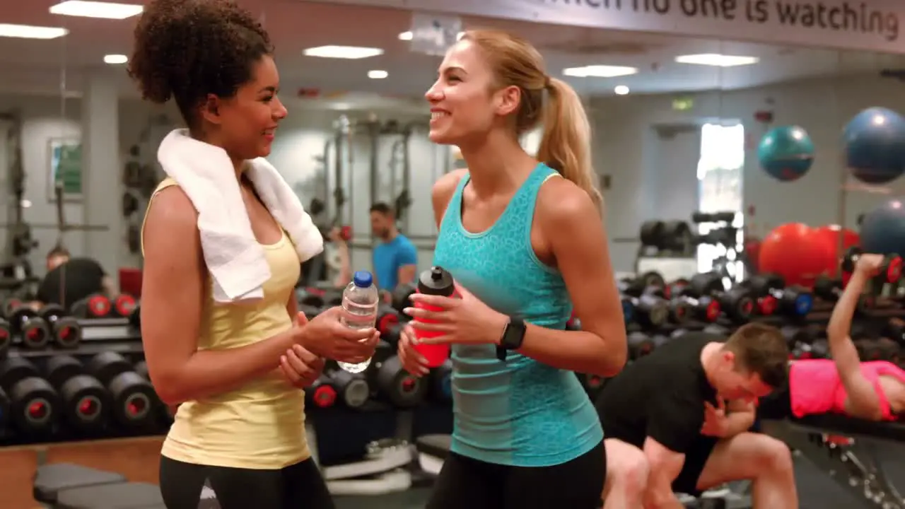 Fit women chatting in the gym