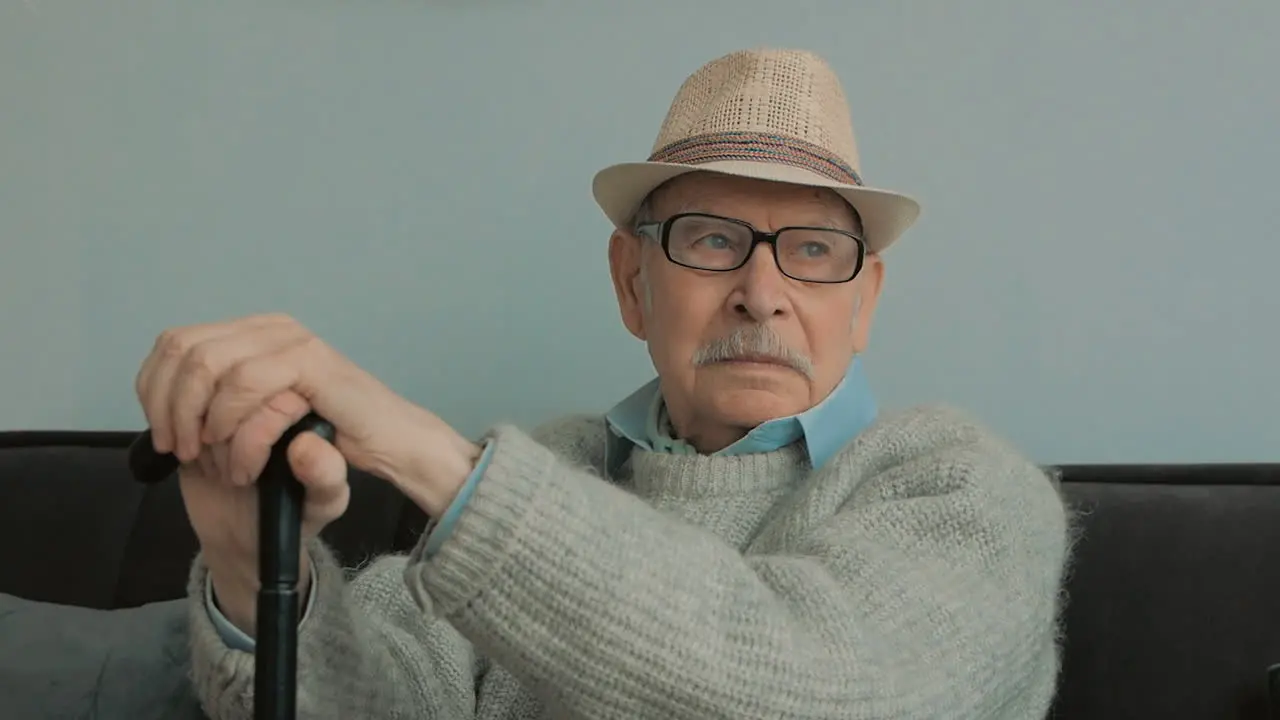 Elderly Man With Gray Mustache Hat Glasses And Cane