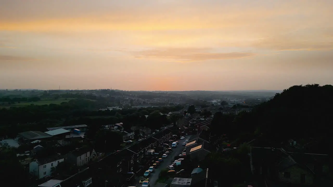 Experience Heckmondwike UK through captivating drone-shot aerial footage highlighting industrial structures lively streets and the historic town center during a summer evening