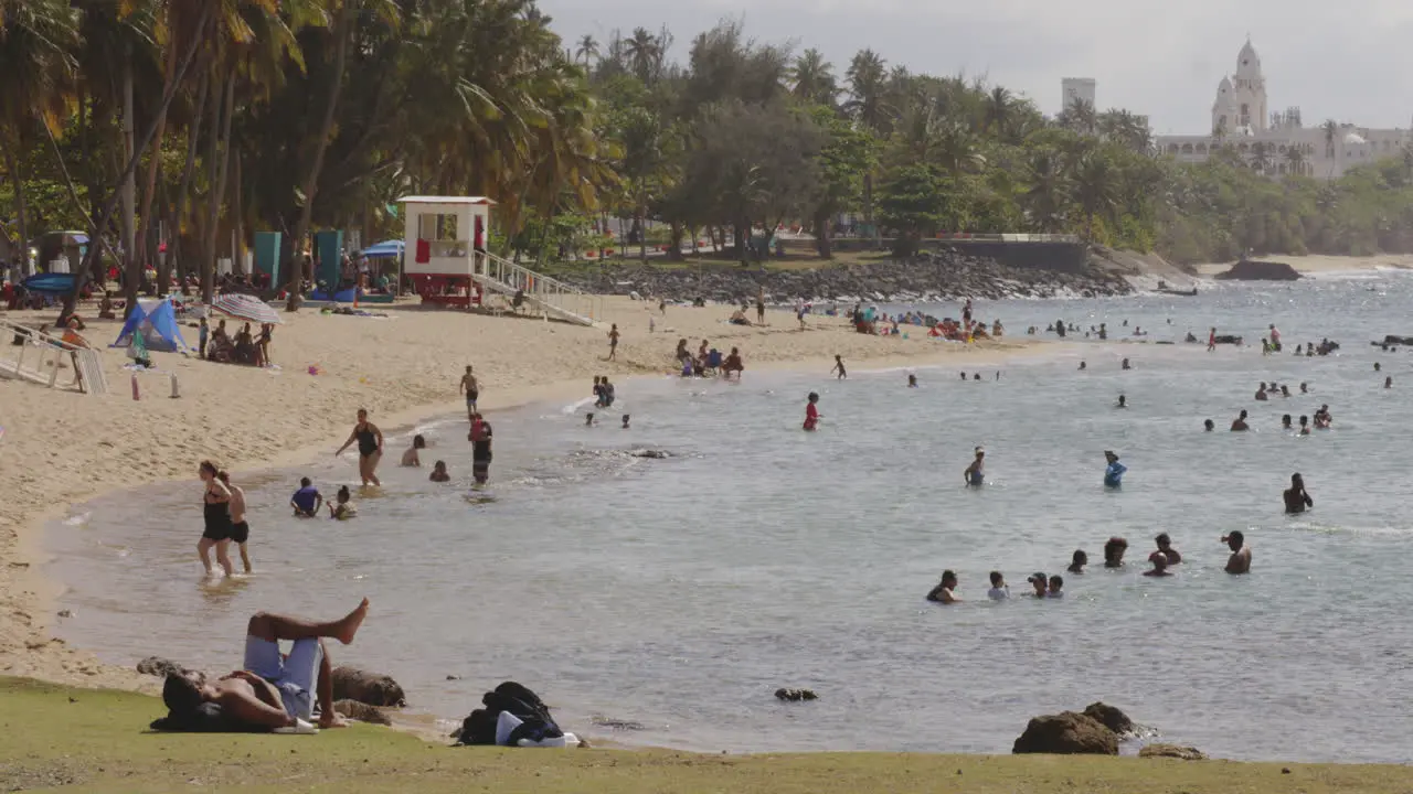 People enjoying the sunshine walking and swimming on the beach in San Juan Puerto Rico