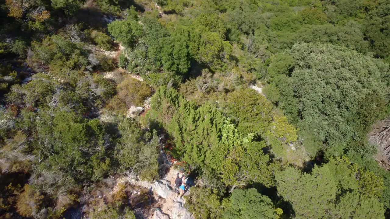 Hiker walking on a path in the middle of mediterranean vegetation of Kefalonia island in Greece