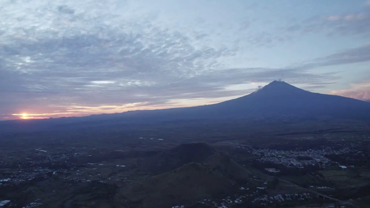 Aerial shot of the Popocatepetl volcano rotating towards the sunset