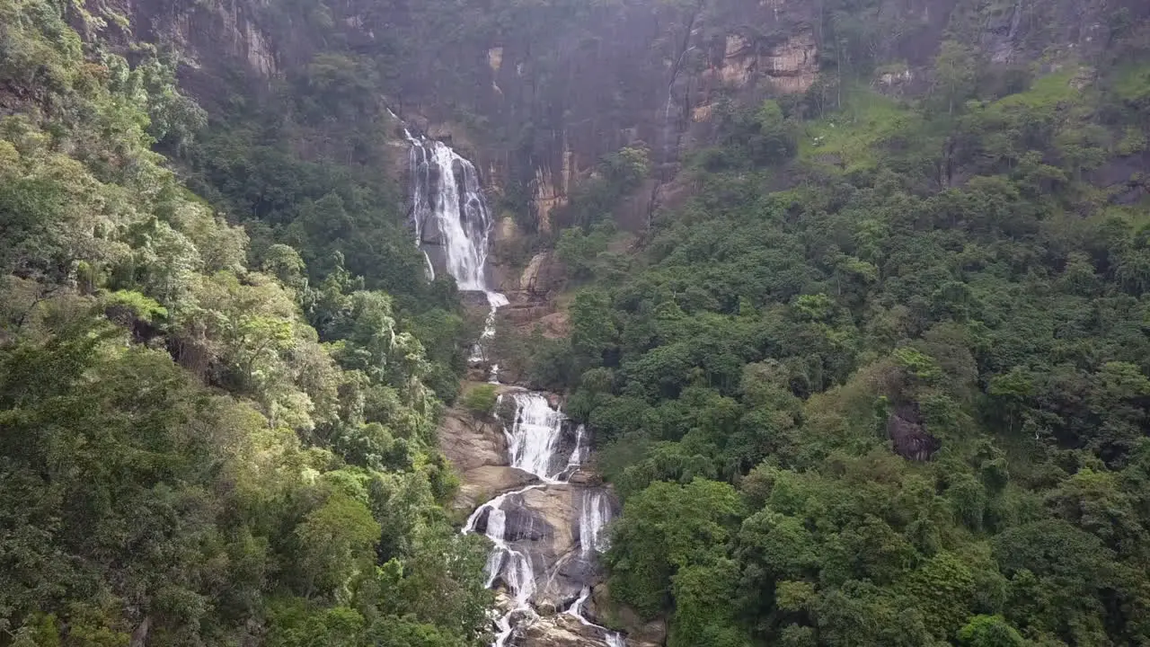 Steep tiered jungle Diyaluma waterfall aerial in Sri Lanka mountains