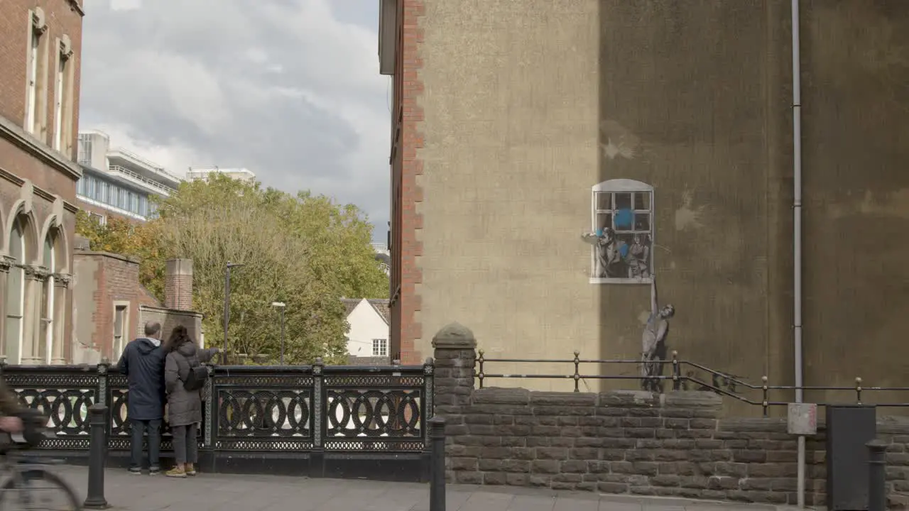 Wide Shot of Banksy Artwork In Bristol City Centre In England