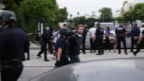 Hollywood Police Officers Guiding Arrested Protesters Away