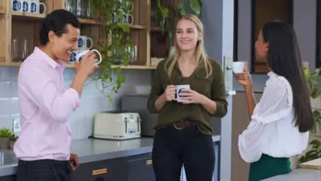 Medium Shot of Work Colleagues Enjoying Their Tea Break 