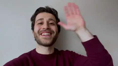 Young University Student Waving Talking and Waving Directly to Camera