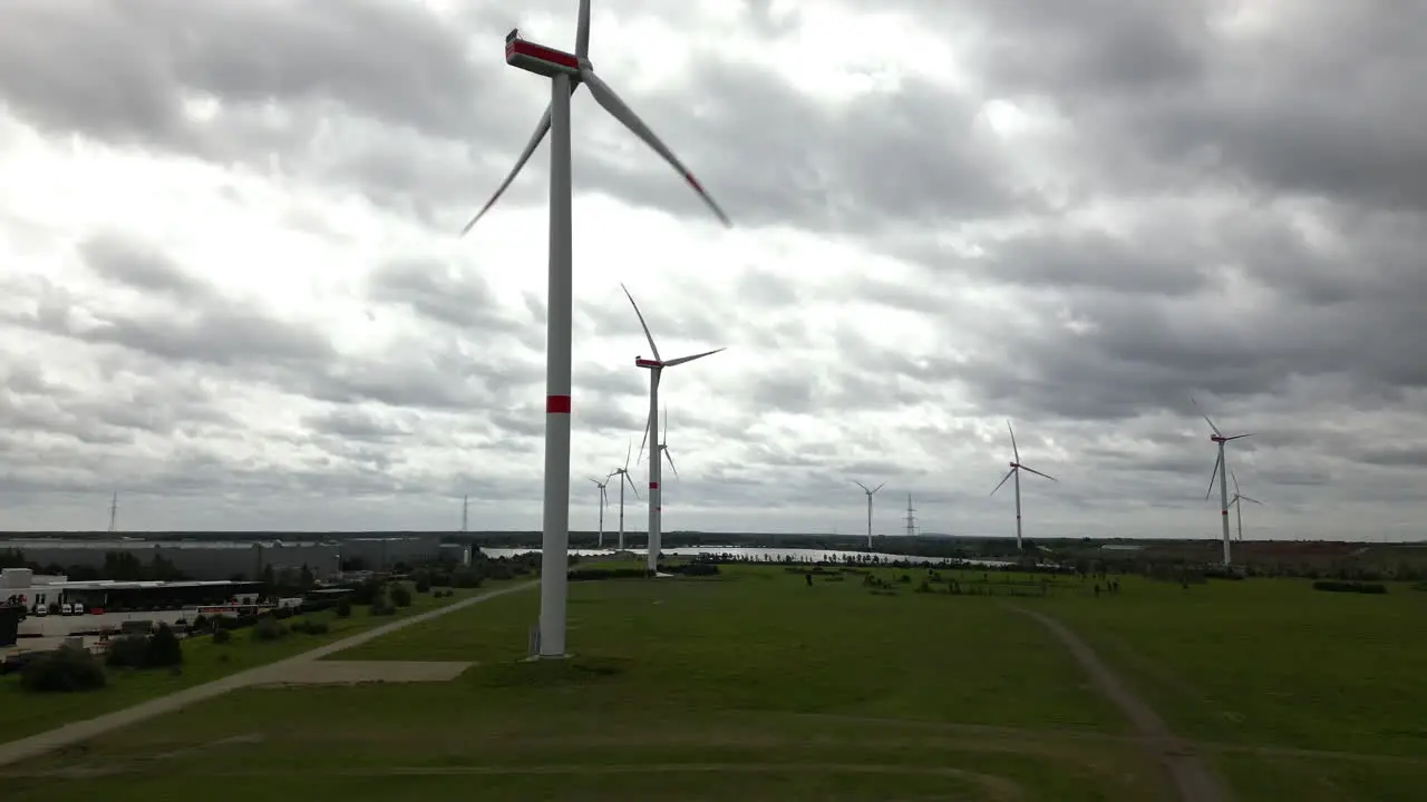 Wind turbines generate electricity on moody day aerial view