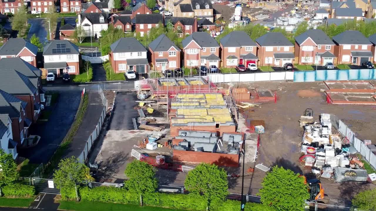 Construction site aerial view above new urban real estate housing development regeneration left dolly