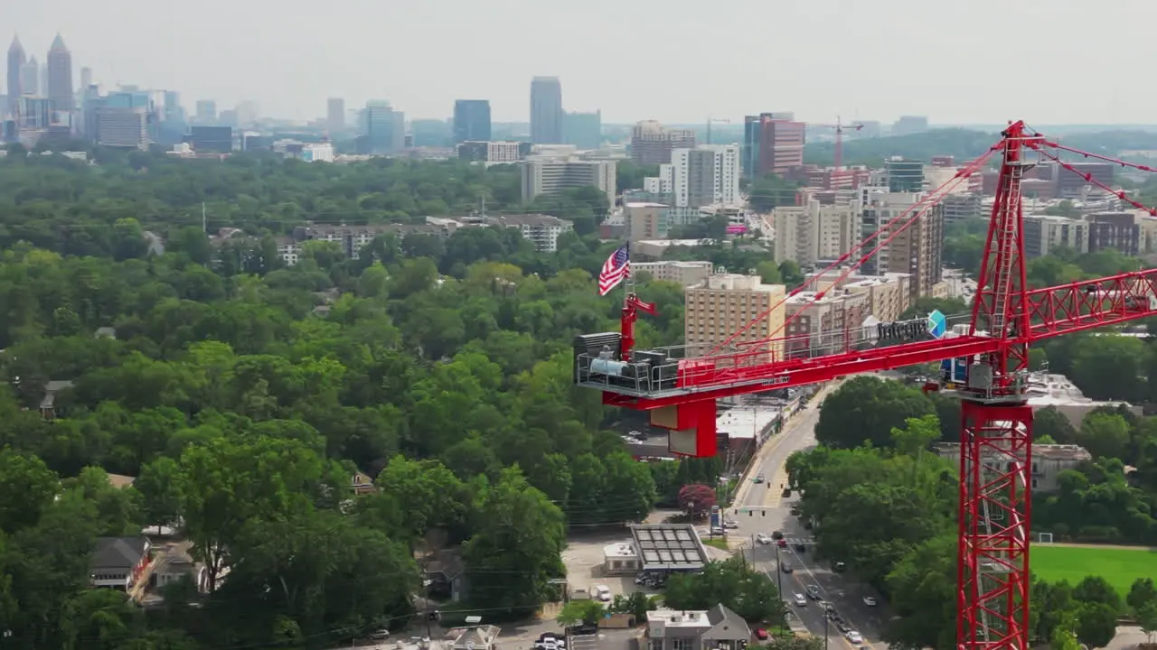 Aerial view of American flag fluttering in wind on tall tower crane