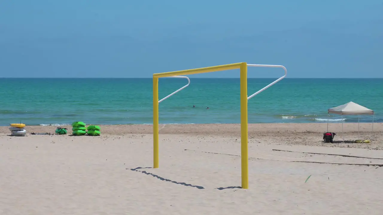 An empty yellow football goal also known as football gate is seen at the beach on the shore of the Mediterranean sea in Alicante Spain