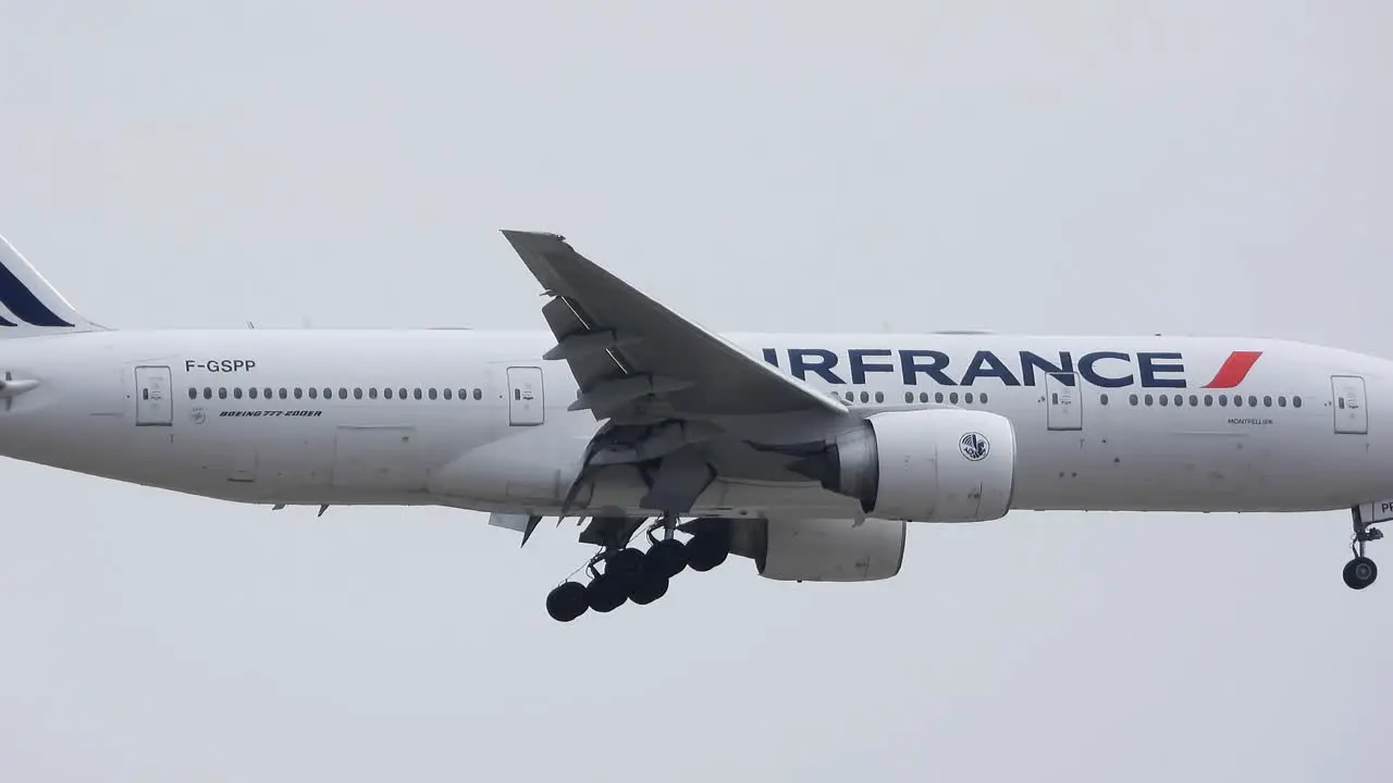 An Air France Boeing airliner extends its landing gear and descends to land