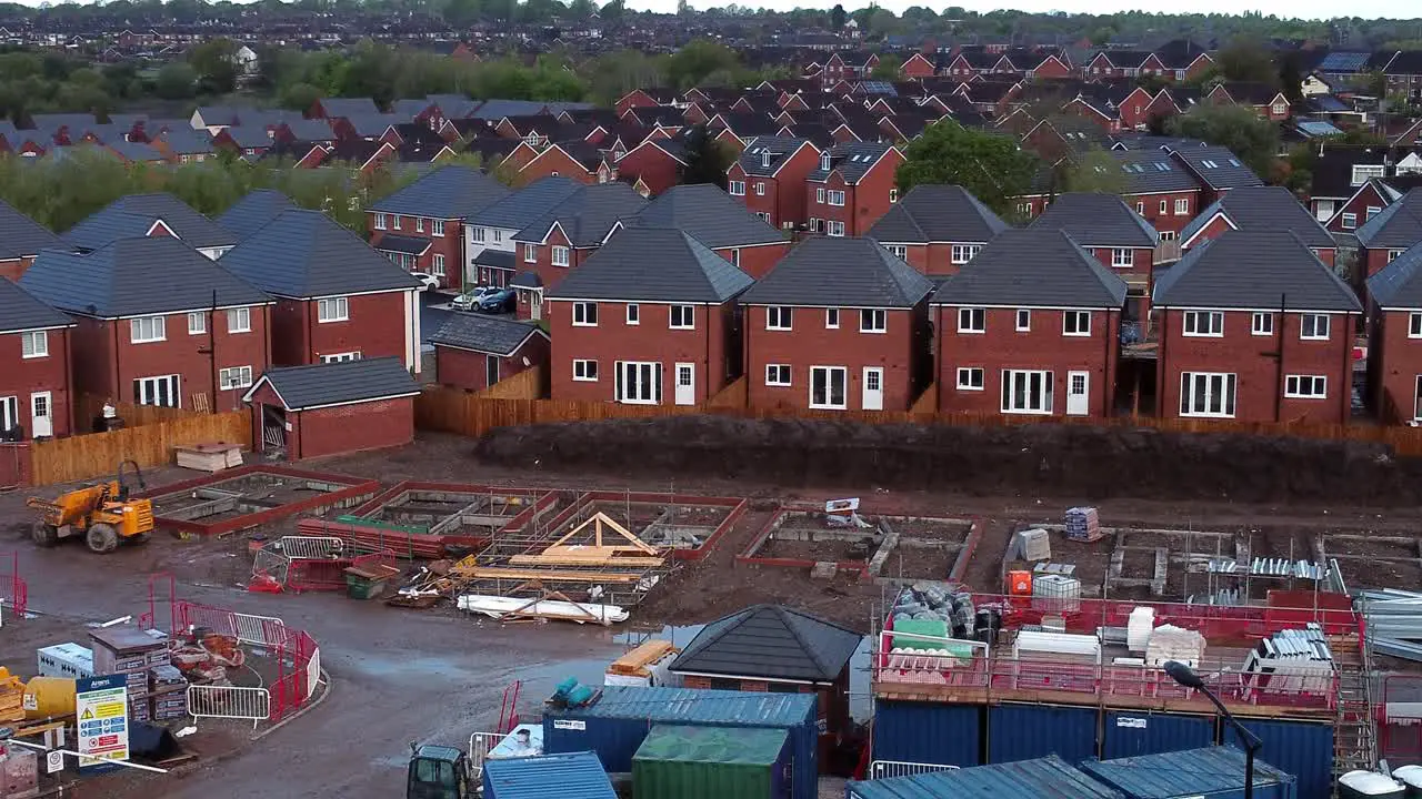 Construction site aerial view above new urban real estate housing development regeneration low push in