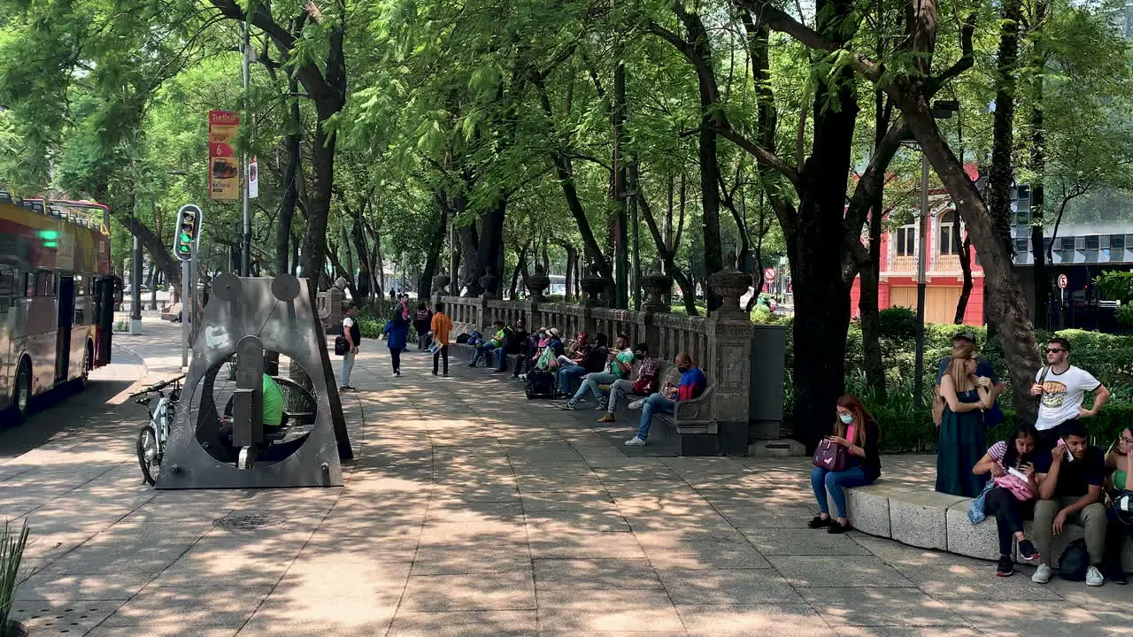 shot of people walking through paseo de la reforma at mexico city daily life