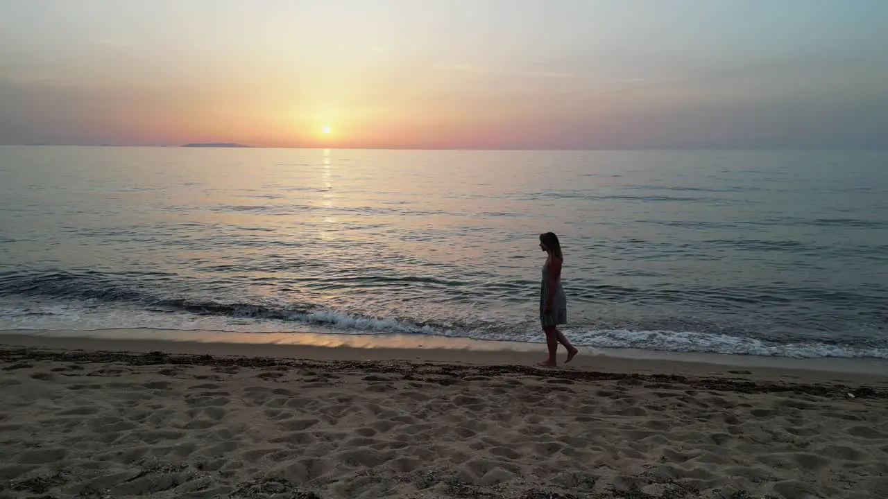 Adult woman walks at sandy beach during sunset in Sardinia Italy Truck Left 4k