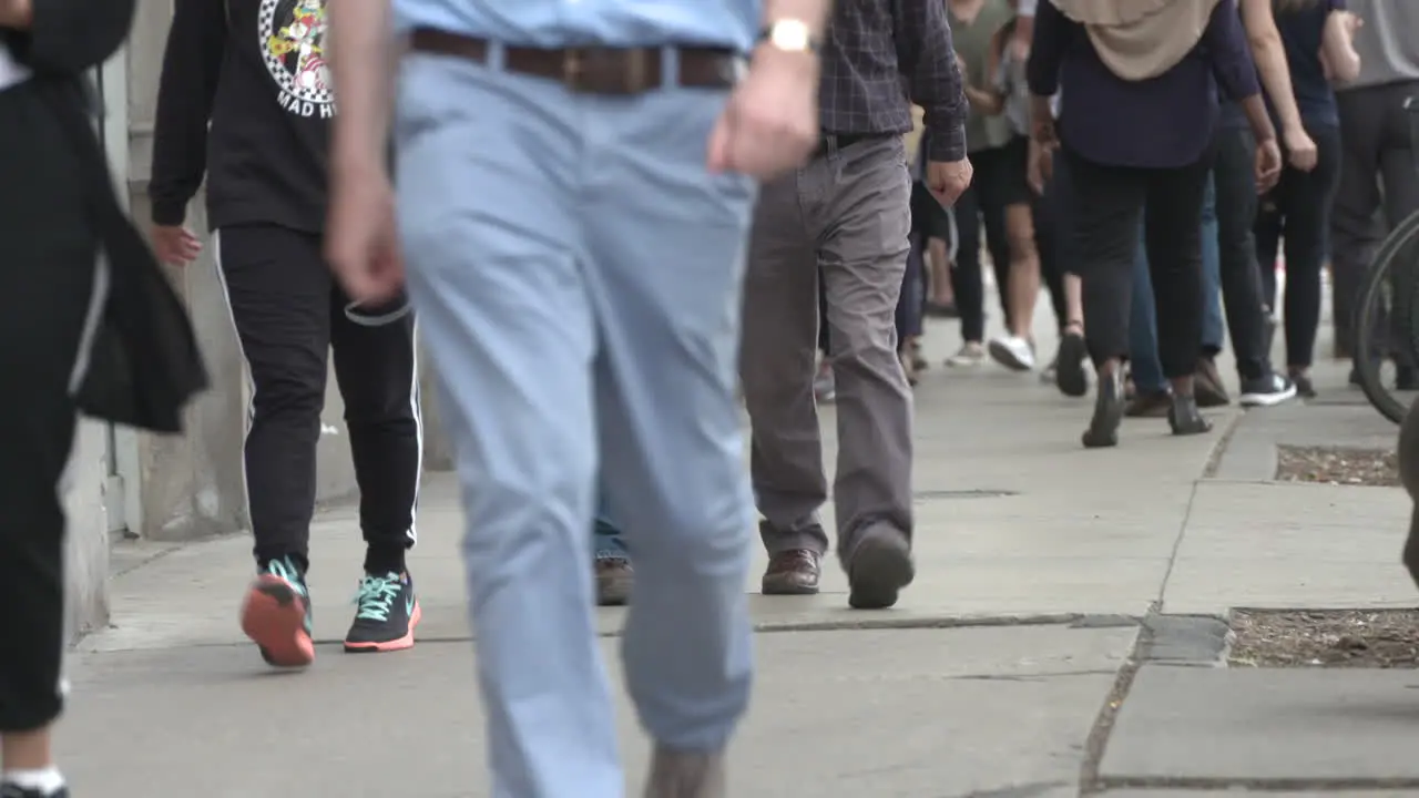 Pedestrians walking down a busy city street