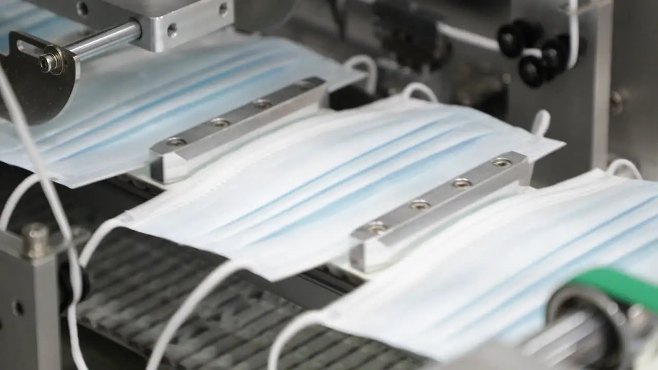 Face Mask With Ear Loops At Production Line In Modern Factory For Air Filtration Protection In Coronavirus Close Up Shot