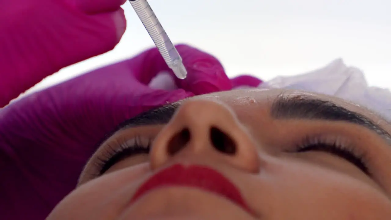 Hispanic woman receiving Botox injections close up