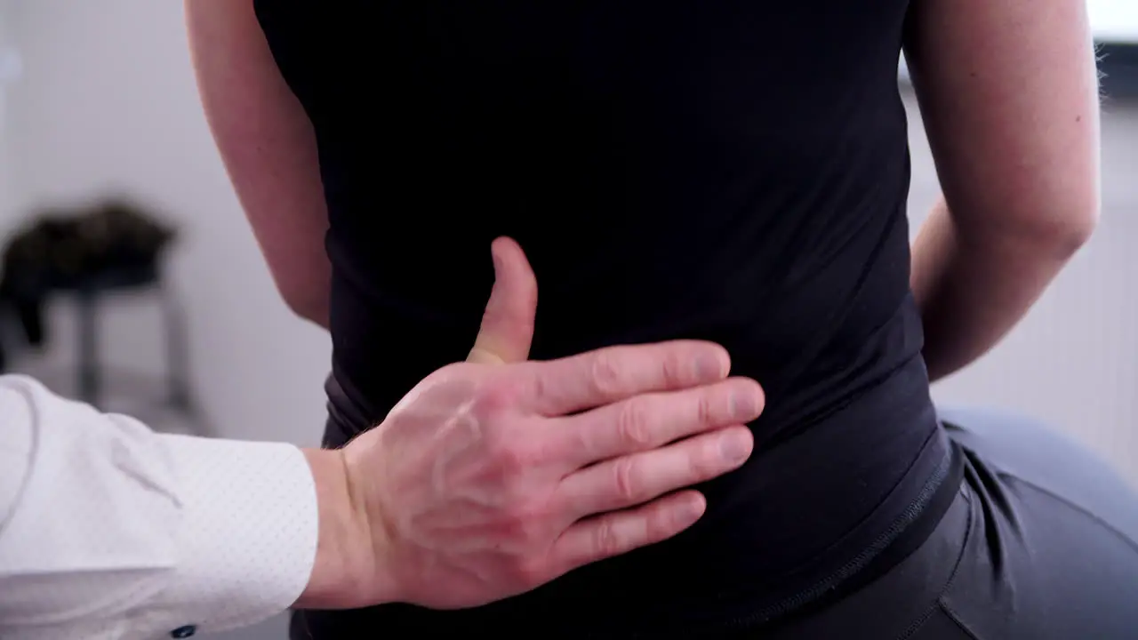 the chiropractor follows the entire spine from neck to pelvis with the thumb for the examination