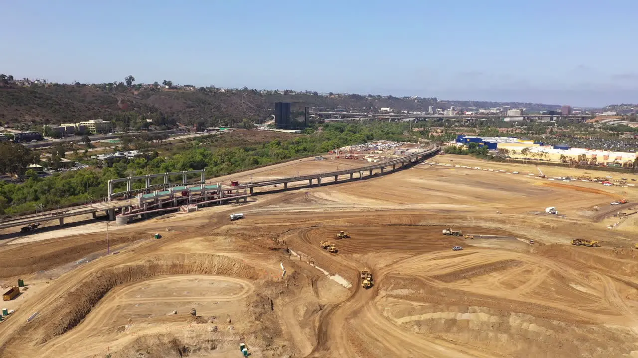 Heavy equipment trucks and bulldozers on construction site drone view