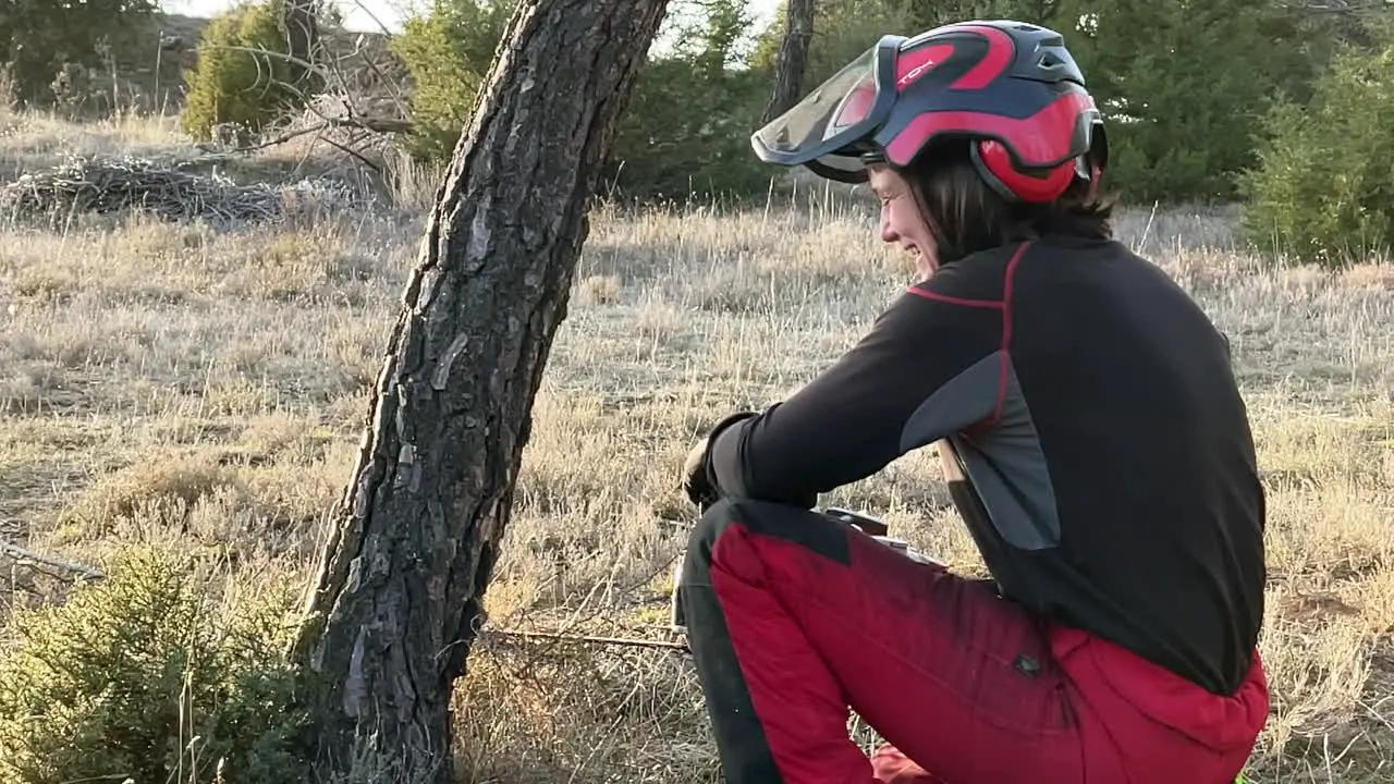 Woman working hard and fighting for equity with chainsaw at pine forest in Europe