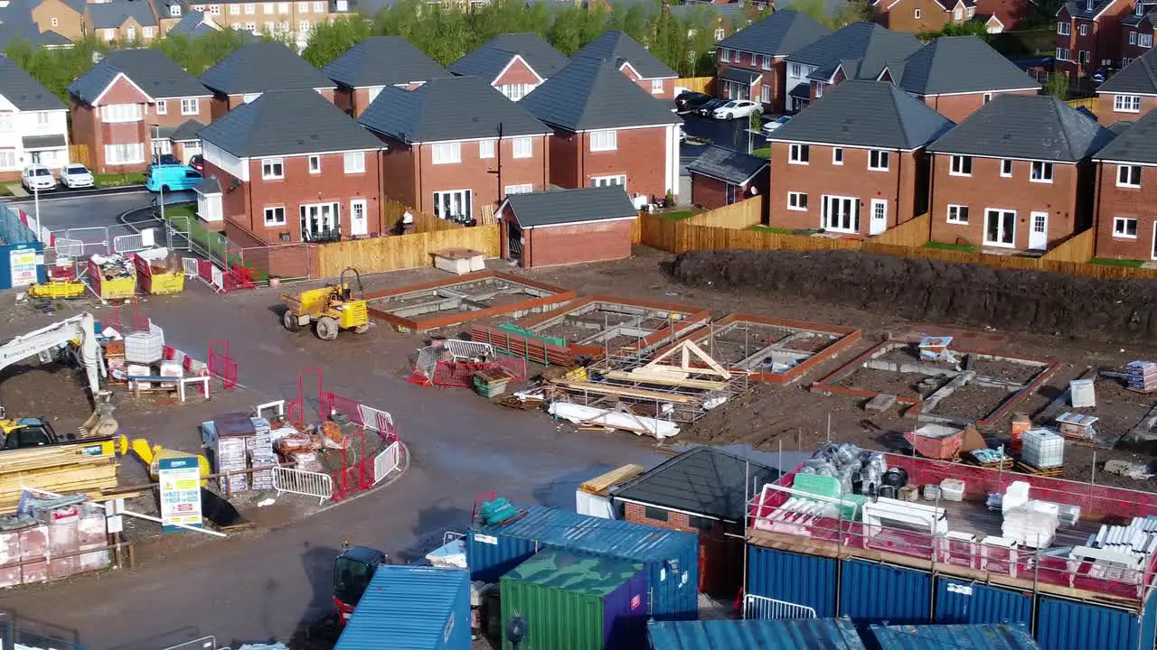 Construction site aerial view above new urban real estate housing development regeneration slow low dolly right