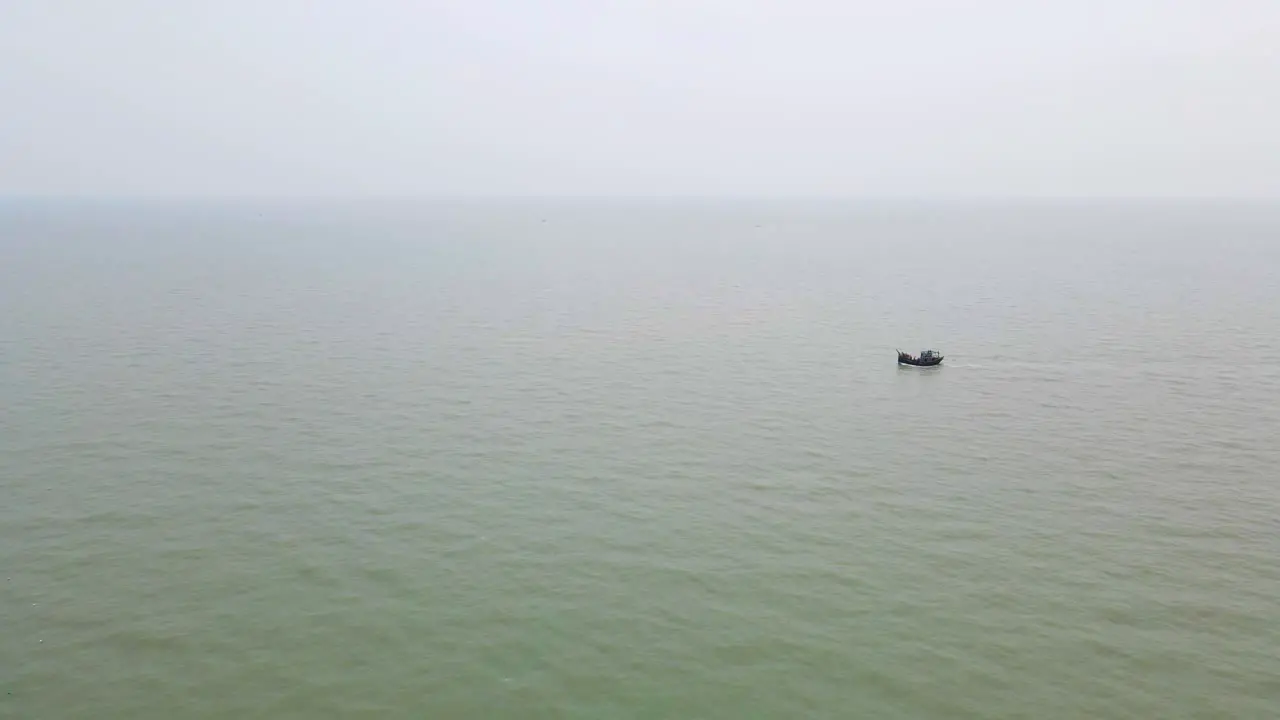 Aerial Tiny Fishing trawler boat at Bay of Bengal sea water near Bangladesh coast