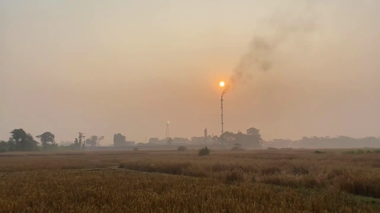 Establisher view of industry pipe releasing fumes in air Bangladesh pan